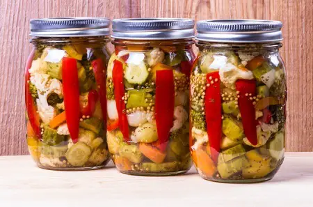 Three jars of preserved mixed vegetables