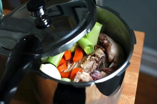 Food inside of a pressure cooker.