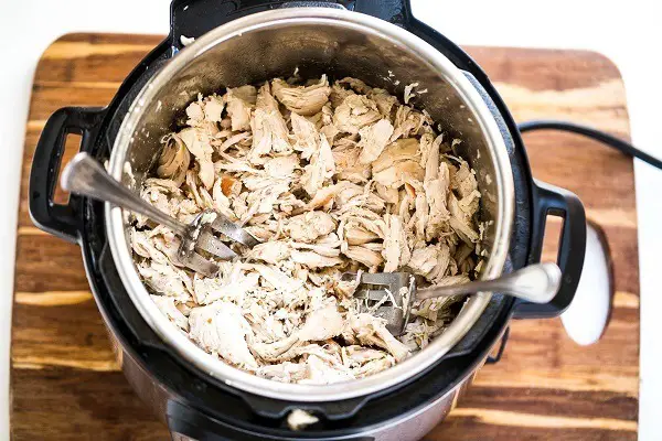 Shredded chicken in a pressure cooker.