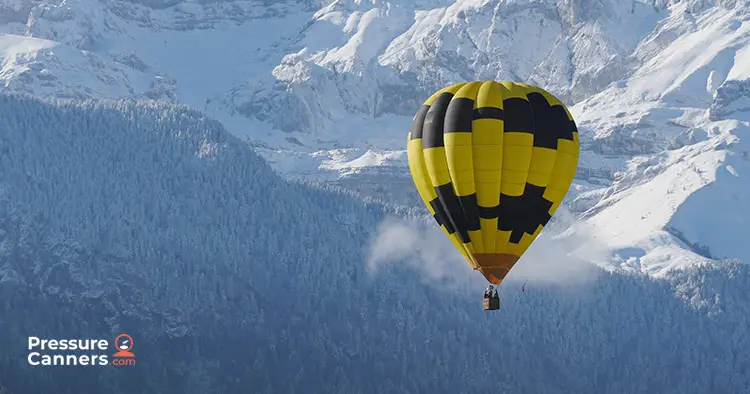 Hot air balloon in snowy mountains