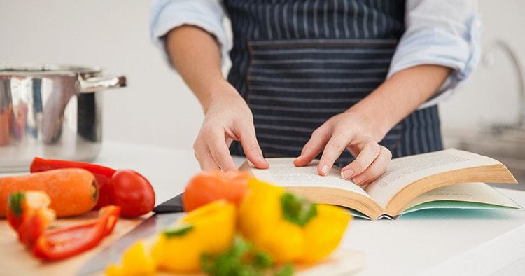 Woman looking in a old recipe book