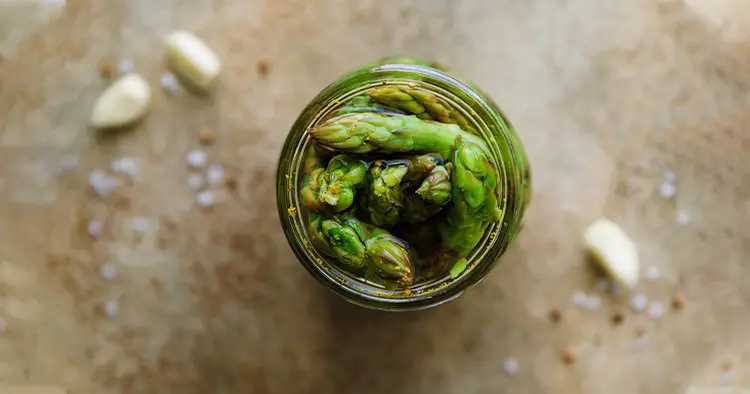 Top view of pickled asparagus in a jar