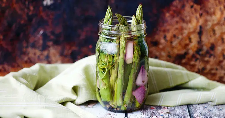 Asparagus with shallot ready to pickle in mason jar
