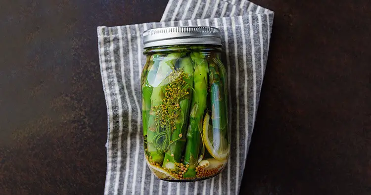 Top view of pickled asparagus in a jar