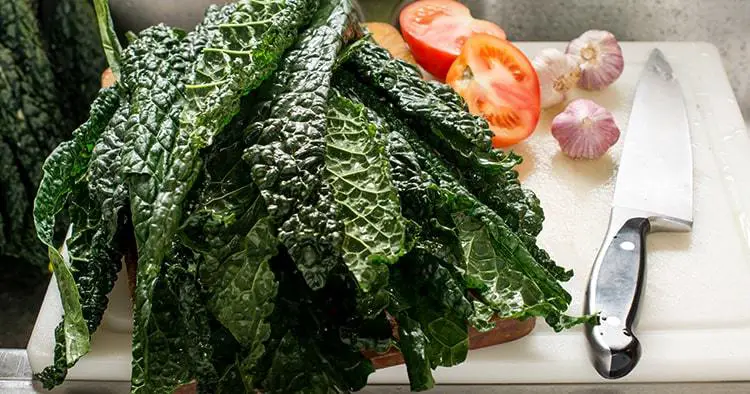 Fresh Organic Kale Leaves on Wooden Cutting Board with Knife