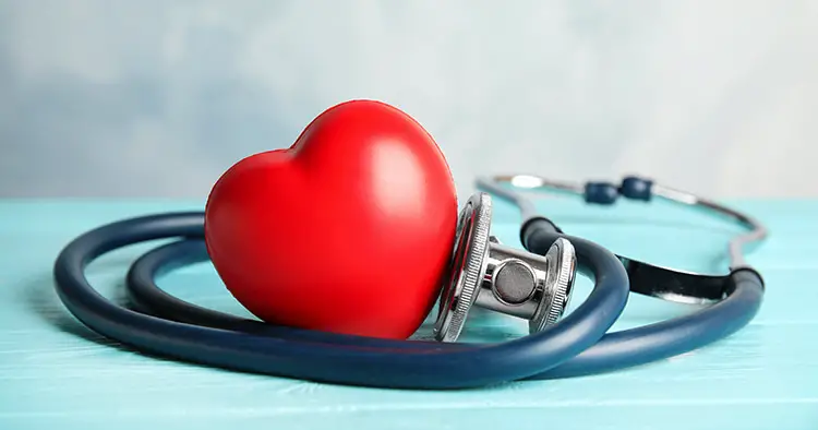 stethoscope-red-heart-on-wooden-table