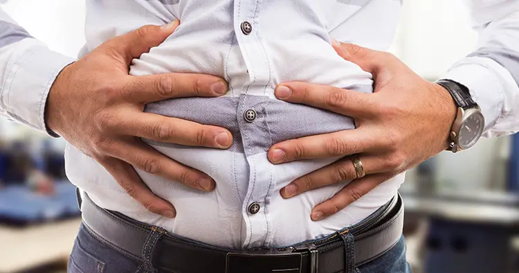 man-pressing-grabbing-bloated-abdomen-belly