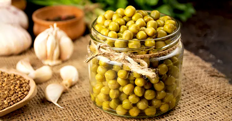 Homemade canned peas in a glass jar. Homemade food