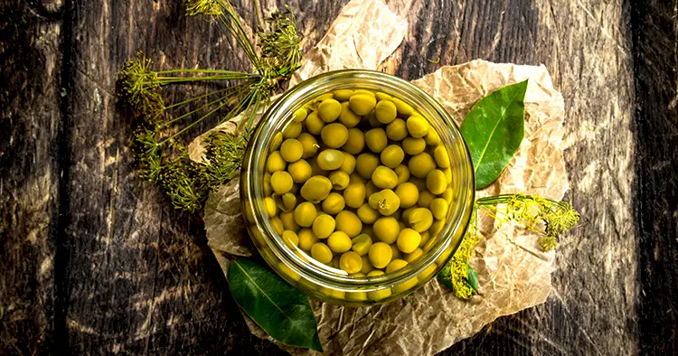 Pickled green peas in glass jar