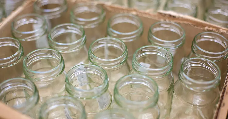 Empty clean glass jars for canning in paper box. Market store