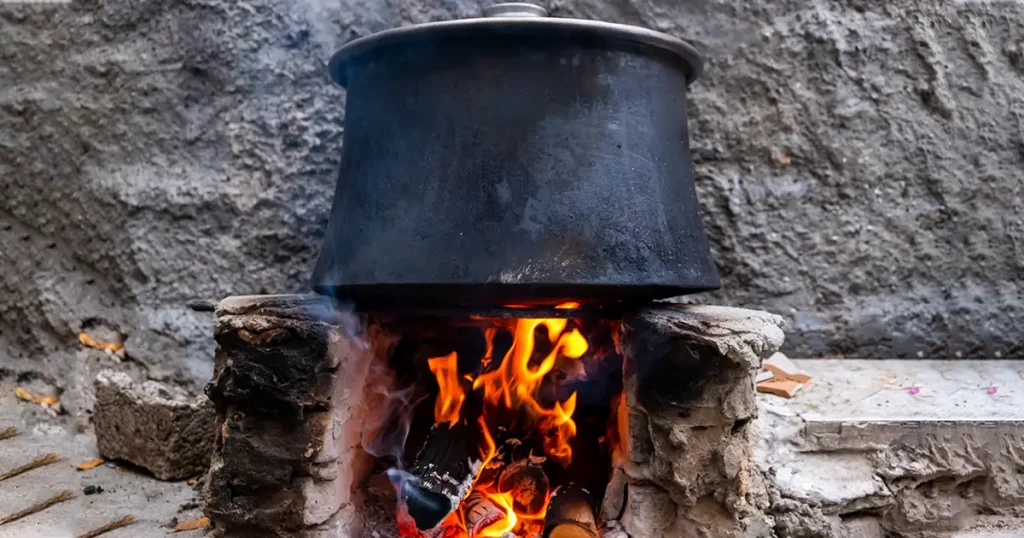 Cooking in a pot on the fire. Camping concept