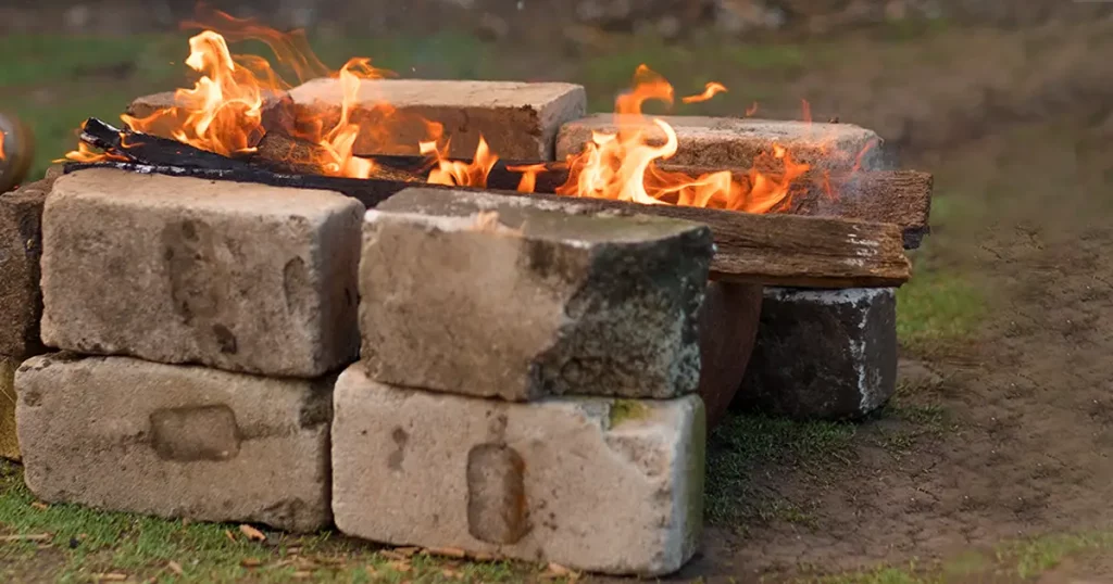 small bonfire with bricks around. Close-up fire on the street.