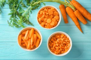 three bowls of carrots - one diced, one sliced, and one disks