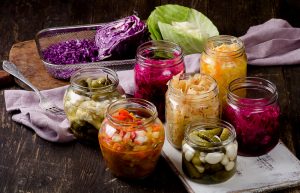 jars of fermented food, cabbage in a glass tray 1/2 sliced